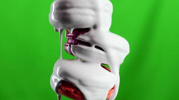 Green background. Stock clip.Maccaroons of different colors are watered,which is watered with white sugar. video