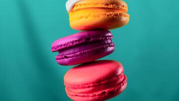 Close up of white glaze draining down the three macarons on a colorful wall background. Stock clip. Sweet food porn concept. video