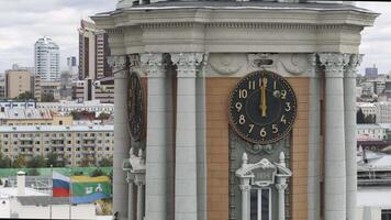Bird's-eye view. Stock footage.A summer landscape of a gray city with a clock tower and offices that stand behind and houses in the center of the city. video