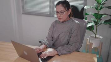 Asian woman working and using laptop at home or office Look at the computer screen, talk, read or write e-mail. video