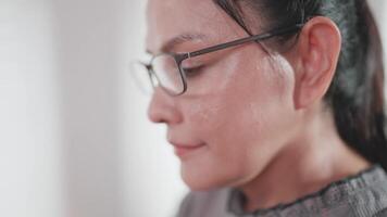 Close-up of a woman looking seriously at the computer screen on which she is working. video