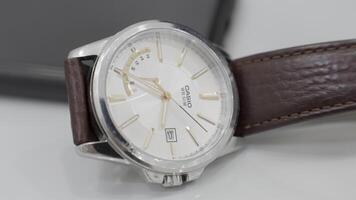 Paris-France,04.07.2022, expensive white watch. Action.Cassio branded watches that lie on a white table and go by time. video