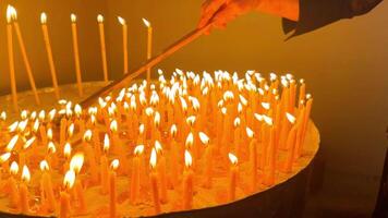 Real view of a burning candle in a church, in a special large candle holder with a candle, slow motion. video