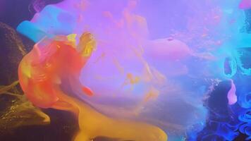 A stunning mix of colors and shapes in the form of floating dust creating a captivating and otherworldly scene.. video