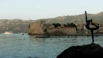Montenegro, Budva - June 1, 2022. Beautiful view of coast with old stone town on background of mountains. Creative. Beautiful ancient city on seashore in Europe. Historic city with beautiful ancient video