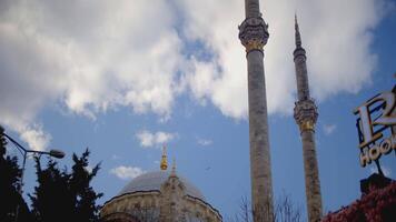 Turkey, Istanbul - October 1, 2021. Bottom view of minarets of mosque in Istanbul. Action. Beautiful minarets rise at ancient mosque. Ortakoy Mosque on shore of Bosphorus on cloudy day video