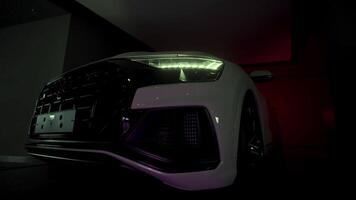 Japan, Tokyo - June 18, 2022. A new white clean foreign car. Action. A big car with no license plates , standing in the cabin and flashing its headlights . video