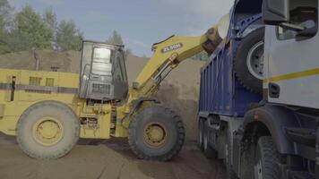 Berlin, Germany - June 20, 2022. Different machines work at a stone quarry. Scene. Industrial background with tractors and trucks loading stones and sand. video
