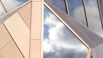 Close-up of facade of glass building with reflection. Stock footage. Top view of glass facade of building. Beautiful modern architecture of glass building video