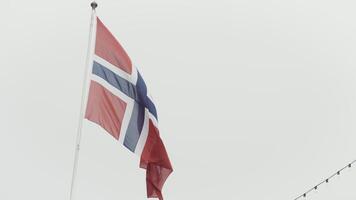 Flag of Norway. Action.A red canvas with a cross hovering over a white sky. video