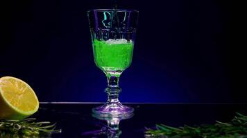 Bright art shooting . Stock Clip . An illuminated purple background that changes color and standing bright alcohol with lemon and fir branches . video