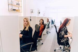 Team of Women Providing Customer Support in Call Center Environment. photo