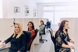 Team of Women Providing Customer Support in Call Center Environment. photo