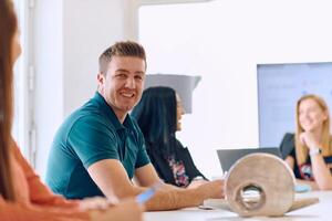 Diverse Business Team Discussing Projects in a Modern Glass Office. photo