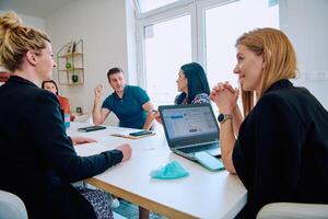 Diverse Business Team Discussing Projects in a Modern Glass Office. photo