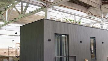 Exhibition of new and modern prefabricated modular house from composite wood panels. Energy efficient panel assembling video