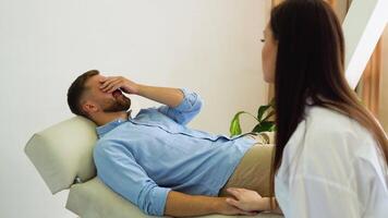 Female psychologist working with male patient in office. A man in despair cries at a consultation with a psychologist video