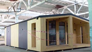 Newly built single storey prefabricated modular building. Prefabricated mobile wooden house at construction site video