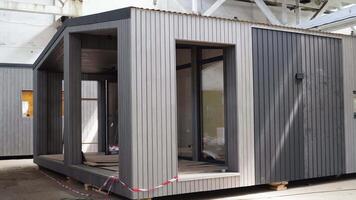 Newly built single storey prefabricated modular building. Prefabricated mobile wooden house at construction site video