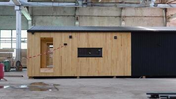 Newly built single storey prefabricated modular building. Prefabricated mobile wooden house at construction site video