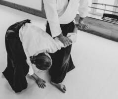 People practicing aikido in a dojo background. photo