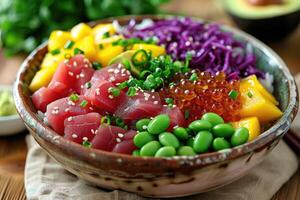 A colorful poke bowl featuring fresh tuna, diced mango, edamame, roe, purple cabbage, and avocado in a ceramic bowl, topped with sesame seeds and green onions. photo