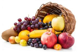A selection of fresh fruits spilling from a basket on a white background photo