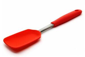 A red silicone spatula isolated on a white background. photo