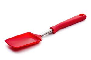 A red silicone spatula isolated on a white background. photo