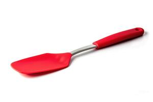 A red silicone spatula isolated on a white background. photo