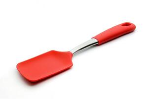 A red silicone spatula isolated on a white background. photo
