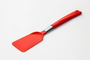 A red silicone spatula isolated on a white background. photo