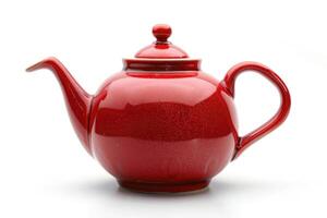A red ceramic teapot isolated on a white background. photo