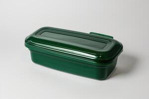 A green plastic lunch box isolated on a white background. photo