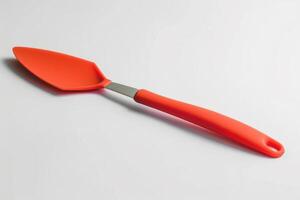 A red silicone spatula isolated on a white background. photo