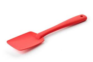 Red silicone spatula on a white background. photo