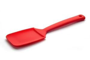 Red silicone spatula on a white background. photo