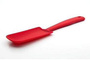 Red silicone spatula on a white background. photo