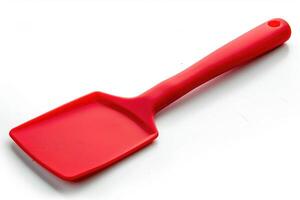 Red silicone spatula on a white background. photo