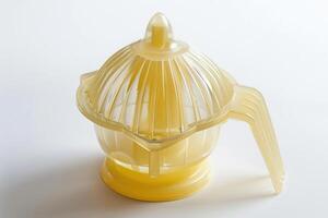 Plastic citrus juicer on a white background. photo