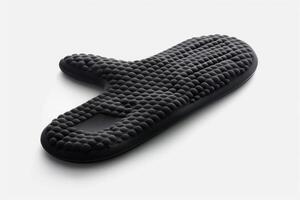 Black silicone oven mitt on a white background. photo