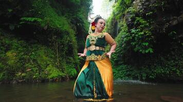 Graceful Balinese Dancer in Serene River Setting video