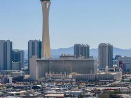 Aerial View of Las Vegas Skyline Featuring Stratosphere Tower Amidst High-Rises and Mountains photo