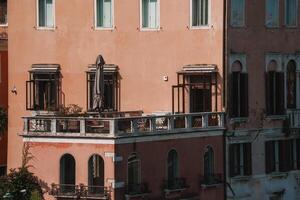 A unique bird's-eye view of a pink building in Venice, with brick and stone facade. photo