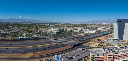 Panoramic Aerial View of Southwestern Cityscape with Highway Interchange and Mountain Range photo