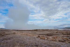 Geothermal Area with Steam Plume and Rocky Terrain in Iceland photo