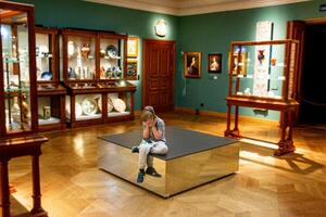 16.07.2023 Cracow. MP. Poland - Young boy observing with interest sculptures photo