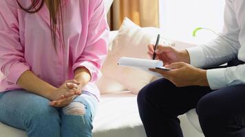Psychologist records the client's history close up. Psychotherapist and patient at an appointment in the office video