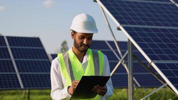 Indian engineer checks the design documentation of the solar station video