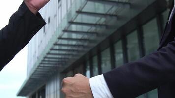 A businessman's hands are greeting in a youthful language and making a casual welcome video